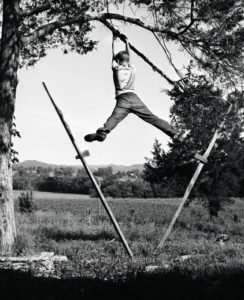 129 W. R. Kelley, Boy hanging on tree