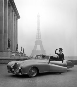 131 Tony Linck, Model posing next to Delahaye auto with Eiffel Tower in background